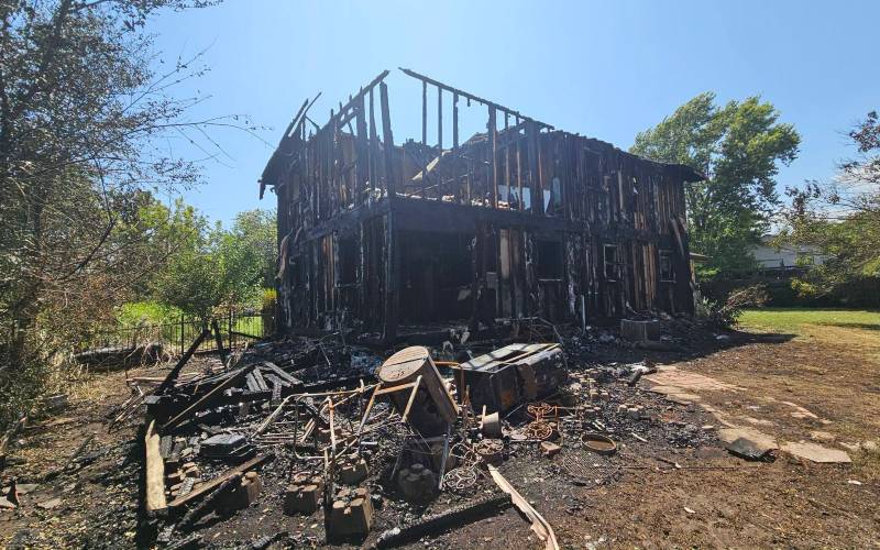 Udall city workers find fire, rescue resident just before blaze guts local home